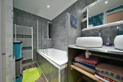 a bathroom with a sink and a bath tub at Pays De L'ours - Pyrénées in Melles
