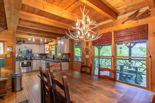 a kitchen with a dining room table and a chandelier at St Johns Ridge in Sugar Grove