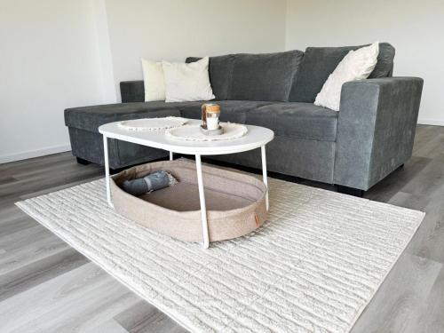 a living room with a couch and a table at Panorama trifft Gemütlichkeit in Nümbrecht