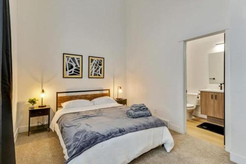 a bedroom with a large bed and a bathroom at 3 Min to DT - 2 Car Garage - Lux Townhome - King Bed in Salt Lake City