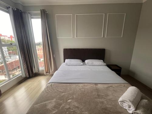 Ένα ή περισσότερα κρεβάτια σε δωμάτιο στο Bom retiro · 6 km Aeroporto/ 1 km do Shopping Garten/2km Square