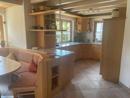 a kitchen with a bench and a table in it at Ferienhaus Eugler in Weitnau