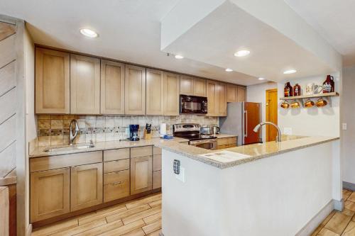 a kitchen with wooden cabinets and a counter top at La Bonte Leisure Beauty in Dillon