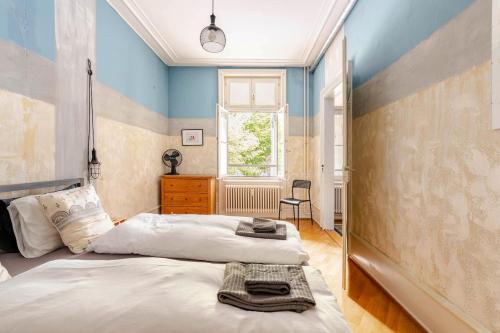 a bedroom with two beds and a window at Historic Gem - Lift - Balcony in Basel