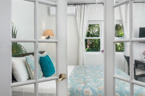 a room with a door with a bed and a table at Karana Studio 2 - K2 in Long Bay Hills