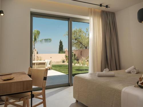 a bedroom with a bed and a table and a desk at Sol in Amoudi