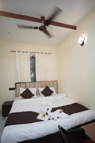 a bedroom with a large white bed with a white ribbon at Om Palace Inn in Varanasi