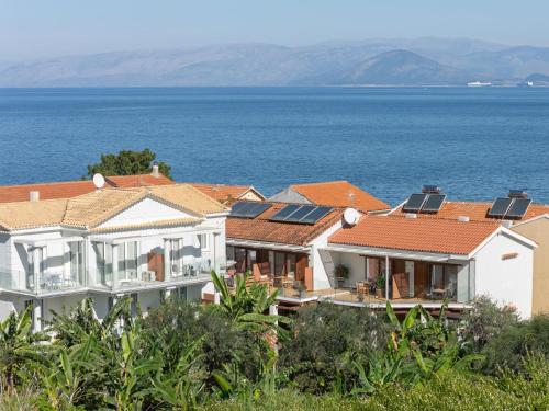a row of houses with solar panels on their roofs at Ayla Corfu in Kavos