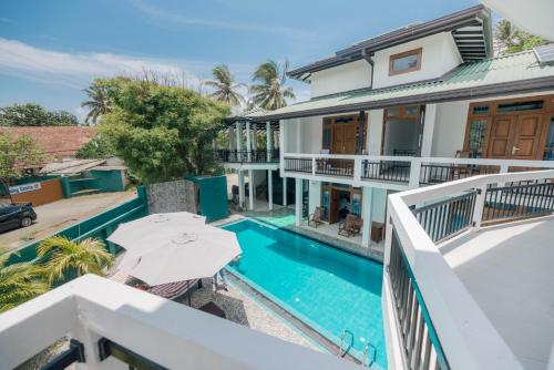 an aerial view of a house with a swimming pool at Teya Beach Hotel in Ahangama