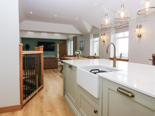 a kitchen with a sink and a counter top at The Old Kipper Hoose in Gardenstown