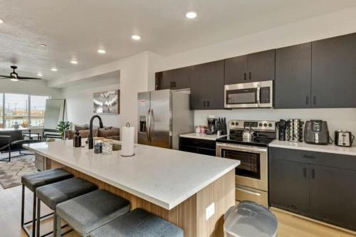 a kitchen with a large island in the middle at 3 Min to DT - 2 Car Garage - Lux Townhome - King Bed in Salt Lake City