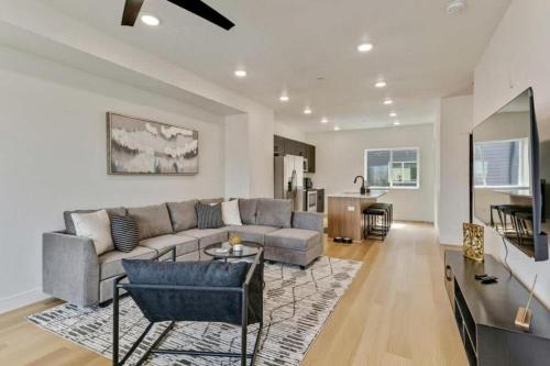 a living room with a couch and a table at 3 Min to DT - 2 Car Garage - Lux Townhome - King Bed in Salt Lake City