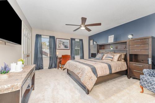 a bedroom with a bed and a ceiling fan at Haven House-10 Min From PTI in Greensboro