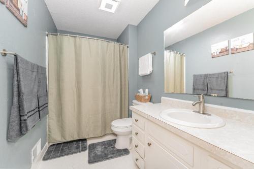 a bathroom with a sink and a toilet and a shower at Haven House-10 Min From PTI in Greensboro
