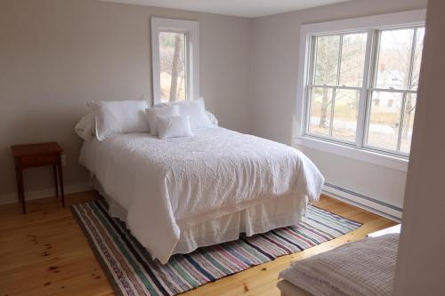 a bedroom with a white bed and a window at Tranquility Near Hudson & The Berkshires in Chatham