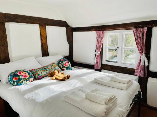 a bedroom with a bed with a teddy bear on it at Log- burner, dog friendly- woodland views with walking trails and local pub on your doorstep! Popular walking trails nearby-Malvern Hills and the Brockhampton Estate- Peaceful village on the border of Hereford and Worcester in Worcester