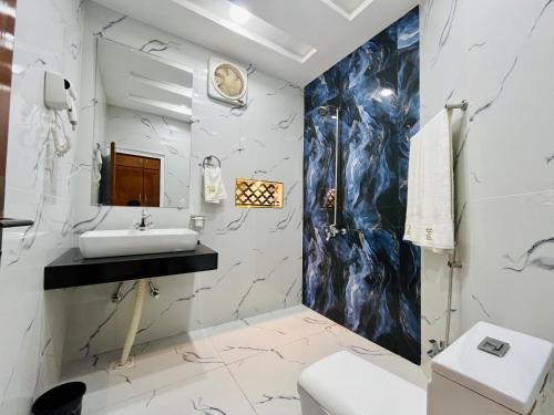 a bathroom with a sink and a toilet at Best Eastern Hotel Multan in Multan