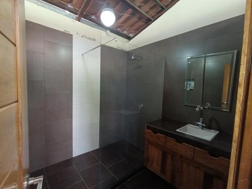 a bathroom with a sink and a mirror at Downtown cabin for families in Macas in Macas
