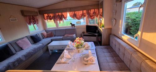 a living room with a couch and a table at Big Family Holiday Home in Skegness
