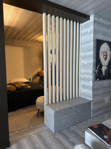 a room with a bedroom with a bed and a window at TORRE OROLOGIO Direttamente sulle piste in Sestriere