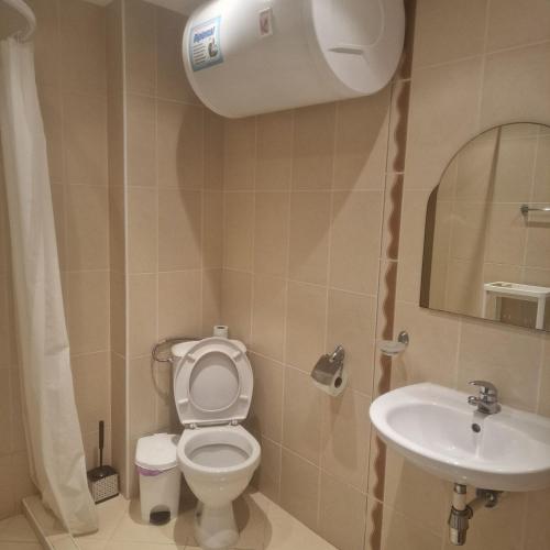 a bathroom with a toilet and a sink at Charming Studio at the Seaside in Aheloy