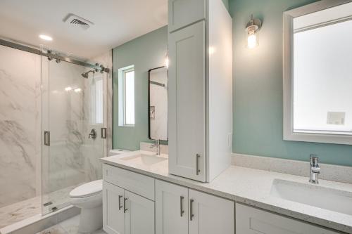 a bathroom with two sinks and a toilet and a shower at Spacious Yard, Near Golf Modern Home in Hollywood in Hollywood Beach