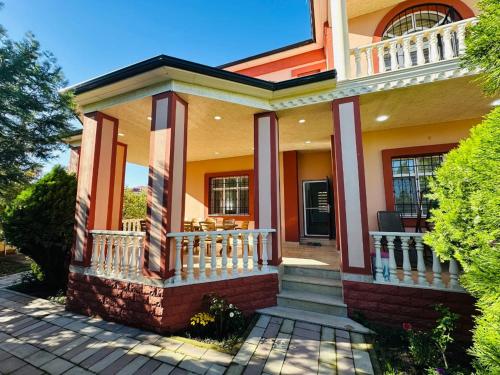 a home with a front porch and stairs at Quba Village Villa in Quba