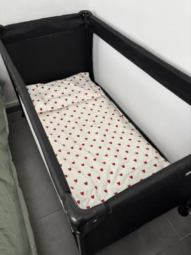 a bed frame with a mattress with hearts on it at Chez Aurore in Port-de-Bouc