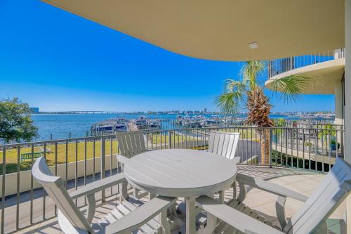 a table and chairs on a balcony with a view of the water at Phoenix on the Bay 1134 condo in Caswell