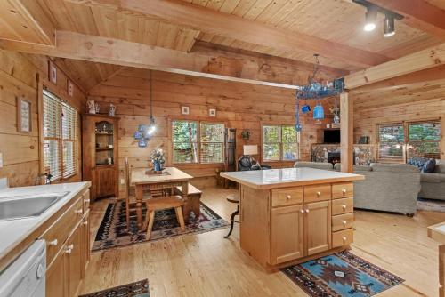 a kitchen and living room of a log cabin at Timber Lodge in Todd
