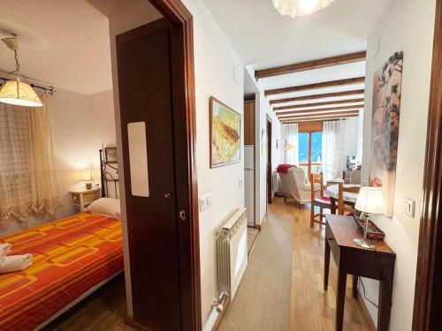 a bedroom with a bed and a dining room at C19 - Bellavista Pirineo - Villmor in Cerler