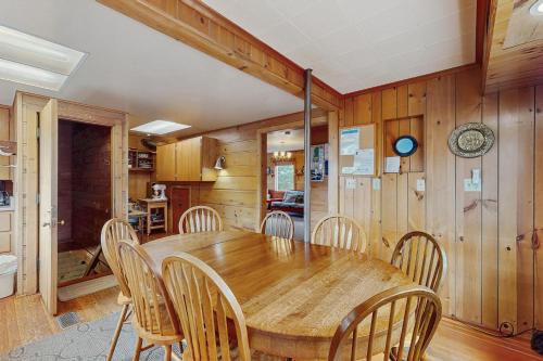 a dining room with a wooden table and chairs at McKinnon's Beach House in Rockaway Beach