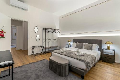 a bedroom with a large bed and a desk at Tiffany - Netflix Disney per 8pp con Garage Box in Trieste