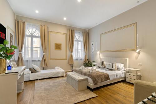 a bedroom with two beds and a large window at Tiffany - Netflix Disney per 8pp con Garage Box in Trieste