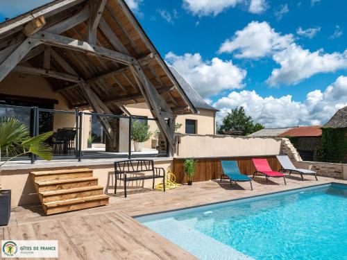 a patio with a pool and chairs and a house at Gite Les Albarets in Rieupeyroux