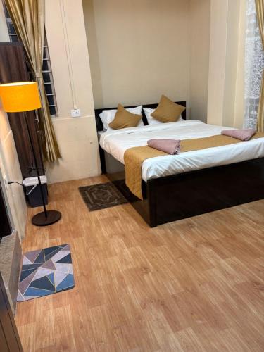 a bedroom with two beds and a lamp in it at The urban rest in Shillong