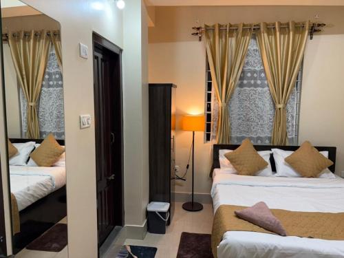a hotel room with two beds and a window at The urban rest in Shillong