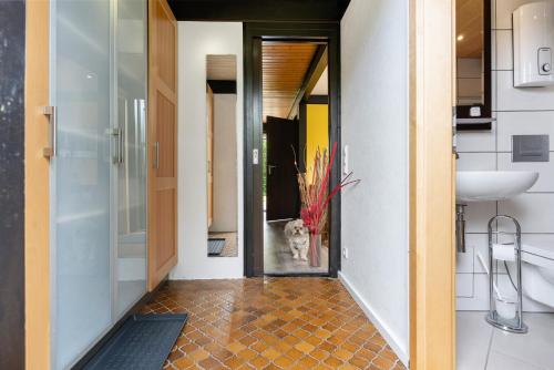 a bathroom with a dog looking out the door at Bungalow Nordschwarzwald in Schellbronn