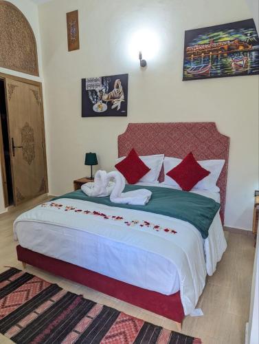 a bedroom with a large bed with towels on it at Dar BERNANI in Rabat