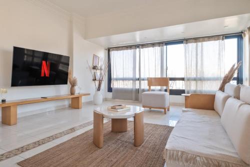 a living room with a couch and a tv at Cozy vintage duplex Khan -khan luxe residence pyramids view in Cairo