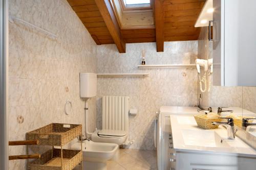 a bathroom with a toilet and a sink at Chalet Maffins 2 in Livigno