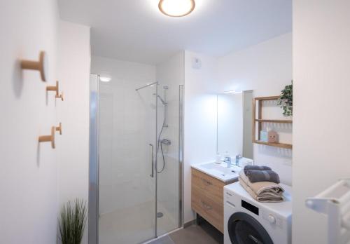 a bathroom with a shower and a washing machine at Sombrero - SILS in Caen