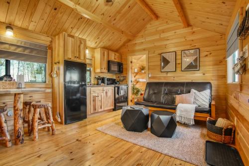 a kitchen and living room in a log cabin at Panoramic Paradise - Hot Tub in Brookville