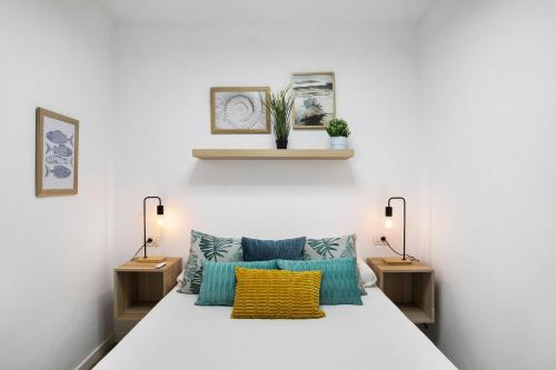 a bedroom with a bed with two lights and two tables at Mypris Home 2 in Tacoronte
