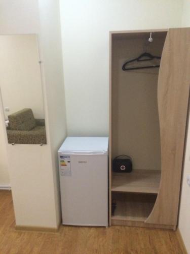 a small refrigerator in a room with a closet at Guest house Hasmik in Yeghegnadzor