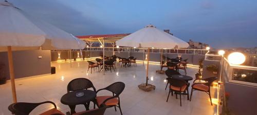 a balcony with tables and chairs on a ship at Phoenix Pyramids View Inn in Cairo