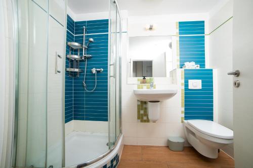 a bathroom with a shower and a sink and a toilet at Viktoria - Park & Stay with a Castle View - Free Parking in Bratislava