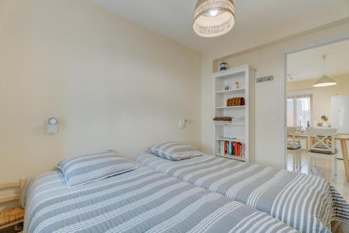 a bedroom with two beds in a room at Grain de vanille in Saint-Benoît-des-Ondes