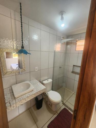 a bathroom with a toilet and a sink at Casa Vista Mar - Iemanjá in Itacaré