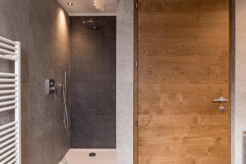 a shower with a glass door in a bathroom at Obergasserhof Apt Waldruhe in Riscone